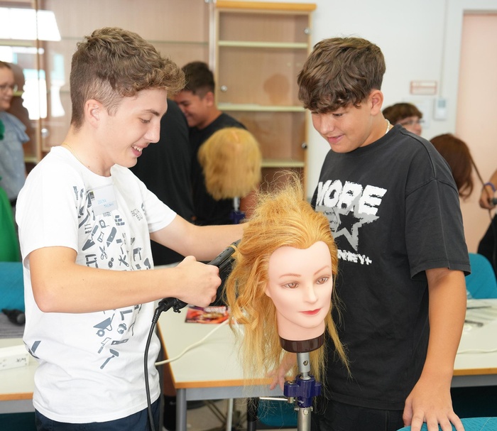 Angehende Lehrlinge beim Stylen von Locken