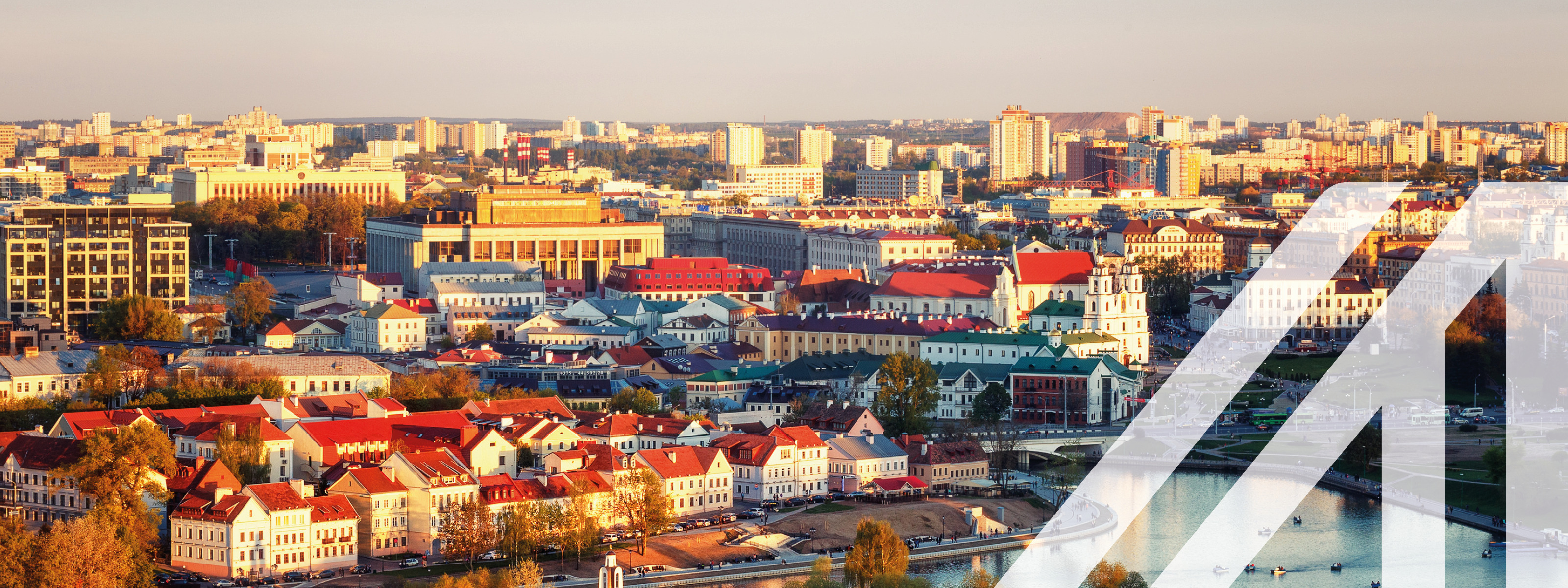 Blick auf  die historische Altstadt von Minsk, Hauptstadt von Belarus; weiße Häsuer mit roten Dächern und Fluß im Vordergrund