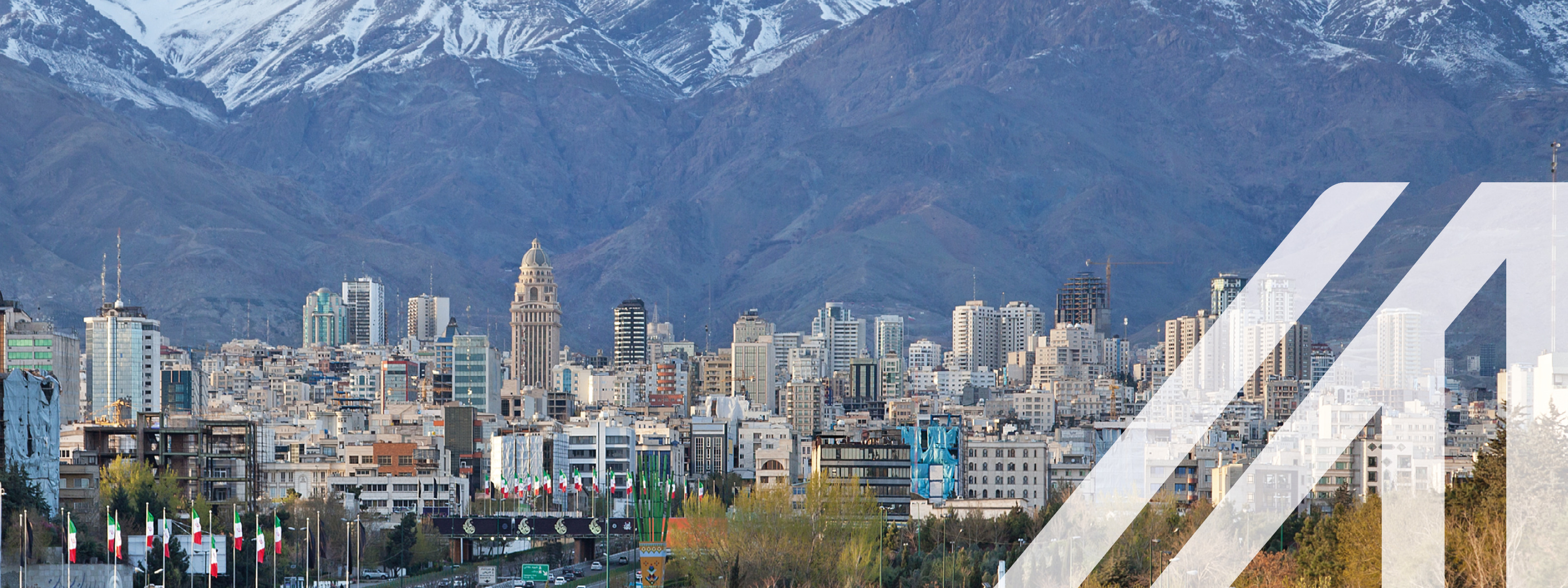 Skyline von Teheran mit Hochhäusern und verschneitem Gebirge