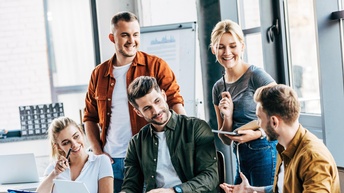 Gruppe von lachenden Personen in Besprechung