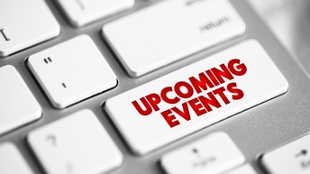 Taste mit Beschriftung Upcoming Events einer weiß-silbernen Tastatur