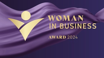 Woman in Business Award 2024 mit goldenem Logo vor lila Hintergrund