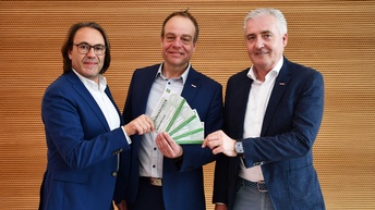 Drei Männer halten WIFI-Bildungsgutscheine