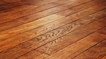 Detailansicht eines dunklen Holzfußbodens mit Maserung in versetzter Anordnung der Bretter