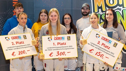 Die drei Erstplatzierten Daniela Schrattenholzer (2. Platz), Lena Prinz (Siegerin) und Celine Kozuh-Schneeberger (3. Platz) im Kreis der Teilnehmer:innen am Lehrlingswettbewerb 2023.