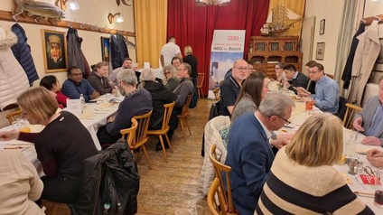 Unternehmer:innen an Tischen sitzend