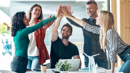 Group of successful smart business team celebrating good job while holding up their right hands on coworking place. 