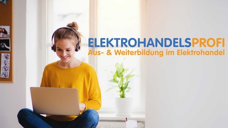 Eine junge Frau sitzt mit Kopfhörern vor einem Laptop