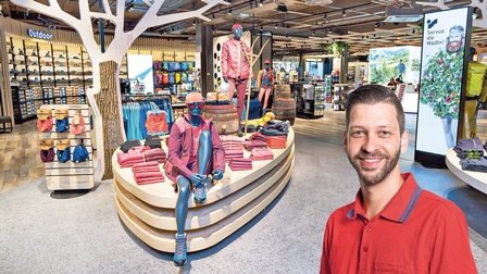 Shopleiter Christian Czettl im roten Shirt begrüßt die  Kunden im EKZ Weinland.