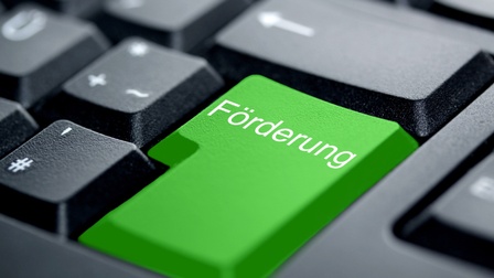Tastatur mit grüner Entertaste mit Aufschrift Förderung