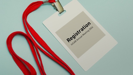 Teilnahme-Badge an einem roten Band