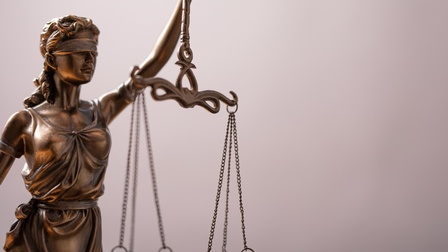 Figur Justitia, die die Waage der Gerechtigkeit in der Hand hält