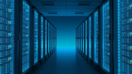 Moderner, blau leuchtender Serverraum: in der Mitte ein gefliester Gang, links und rechts Serverracks.