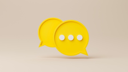 Grafische Darstellung zweier gelber Sprechblasen, in einer drei weiße Punkte