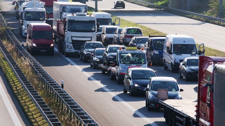 Auf einer mehrspurigen Autobahn stehen in einer Fahrtrichtung im Stau. In die andere Fahrtrichtung fahren die Autos