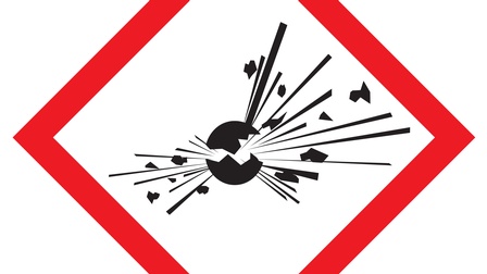 Schwarzes Symbol Kugel, die zerspringt, Linien und Teilchen vom Zentrum ausgehend rot quadratisch umrandet auf weißem Hintergrund