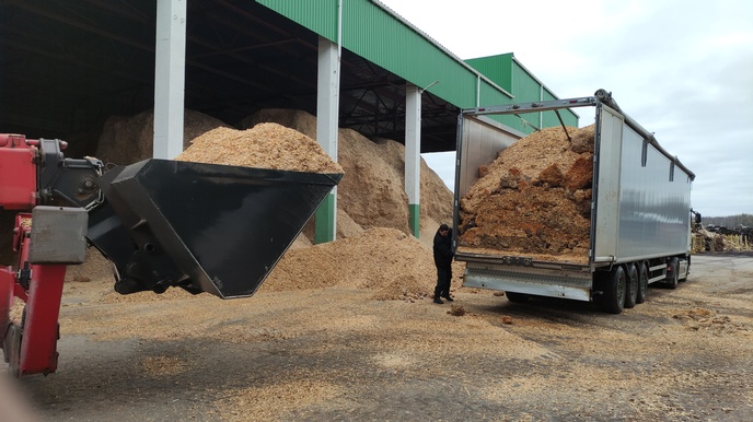 LKW entlädt Sägespäne bei Lagerplatz
