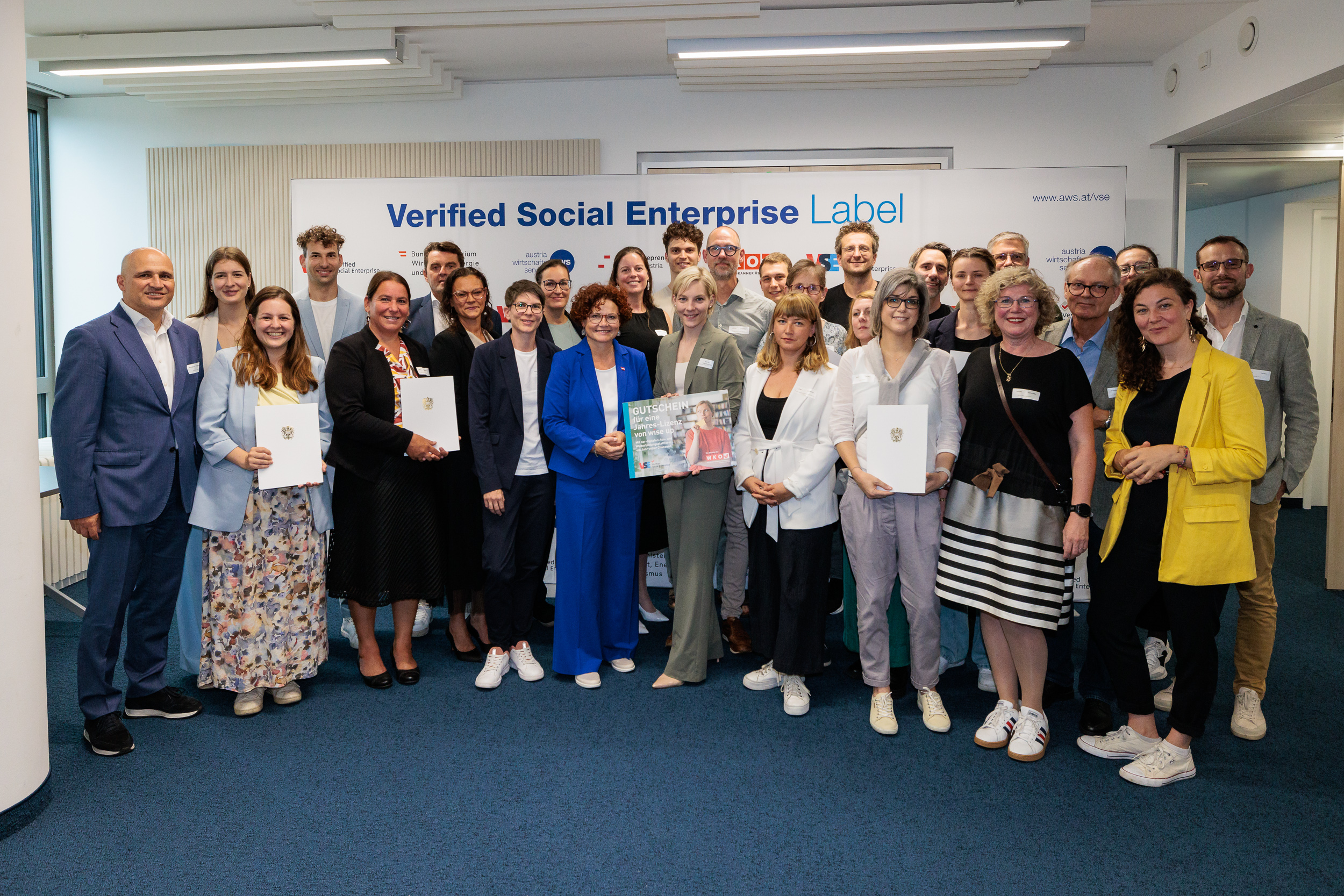 V.l.n.r. Bernhard Sagmeister (Geschäftsführer aws), Staatssekretärin Elisabeth Zehetner (BMWET), Bettina Dorfer-Pauschenwein (Vizepräsidentin WKÖ), Lena Gansterer (stellvertretende Vorstandsvorsitzende SENA) mit den 15 neuen VSE-Label-Tragenden.