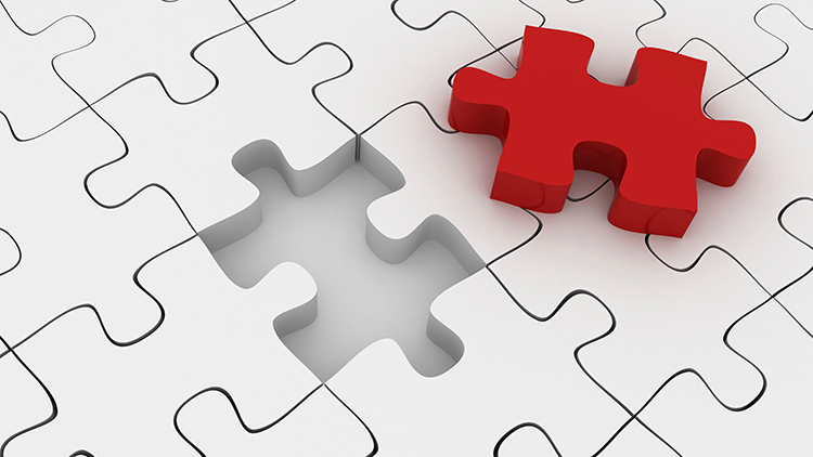 Rotes Puzzlest&uuml;ck hebt sich aus wei&szlig;en Puzzleteilen hervor