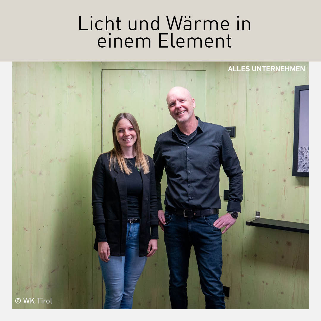 Alexandra Vercayie und Thomas Hackl von der HL Innovation GmbH stehen lächelnd vor einer holzverkleideten Wand.