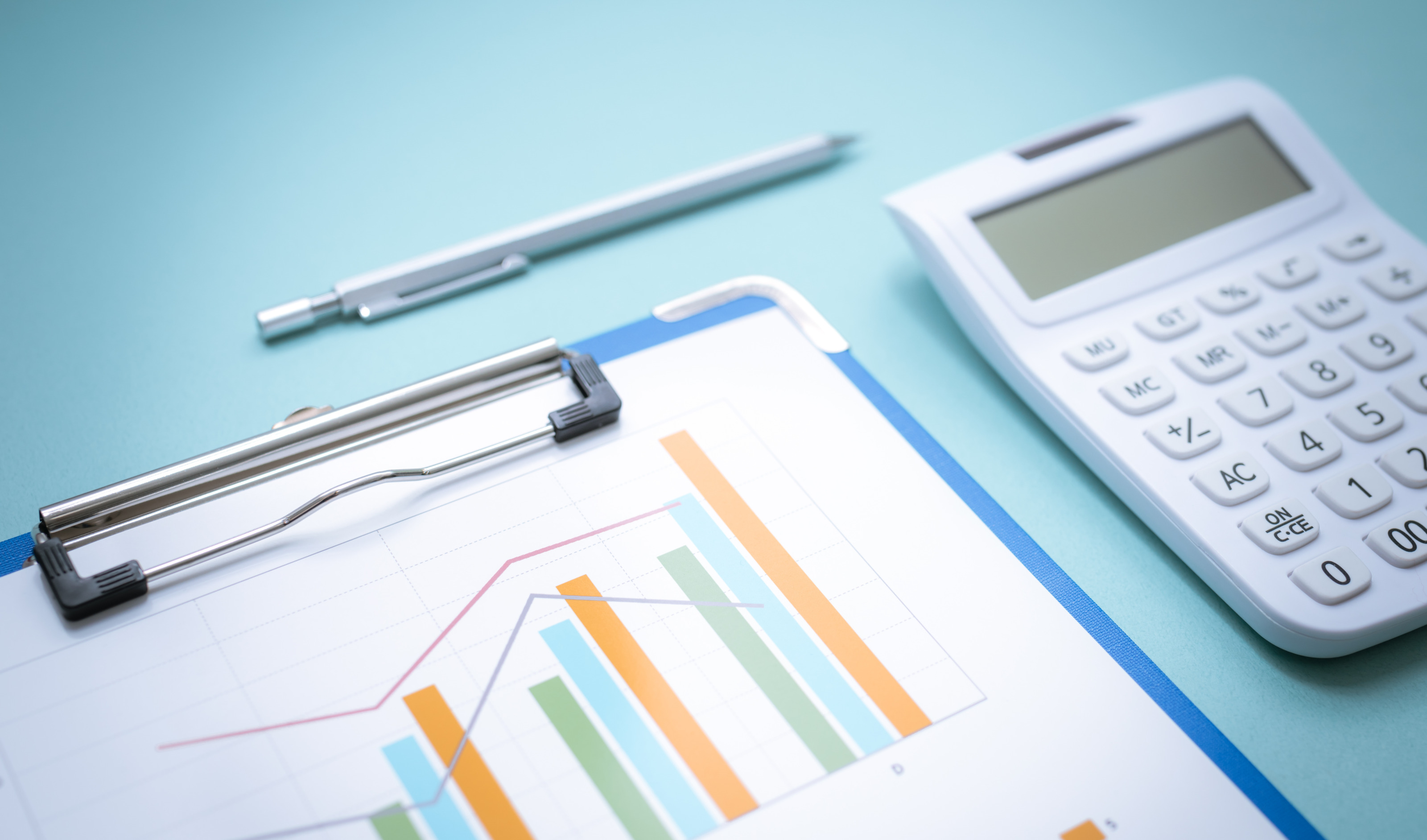 Clipboard mit Diagrammen, nebenbei Taschenrechner und Stift liegend